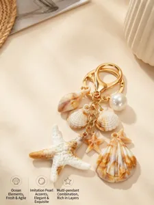 Detail of sea-themed keychain featuring starfish, shells, and a pearl pendant