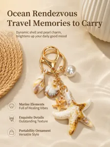 Close-up of ocean-themed starfish and shell keychain with pearl detail on sandy background