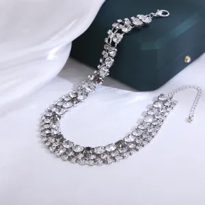 Exquisite multi-row crystal rhinestone statement necklace, perfect jewelry detail for party wear.