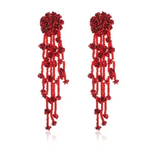 Detailed close-up of red beaded rose tassel earrings, featuring intricate floral drop design.
