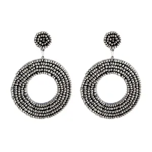 Detailed close-up of handmade resin seed beaded round earrings showing texture and details.