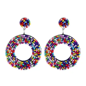 Detailed close-up view of handmade colorful resin beaded bohemian circle earrings