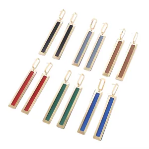 Detailed view of long geometric metal drop earrings with colorful rectangle enamel design.