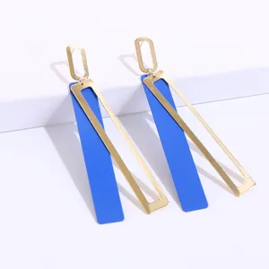 Geometric blue and gold drop earrings detail showcase, modern long metal design close up.