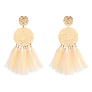 Boho fringe tassel statement earrings with gold textured round drop design details.