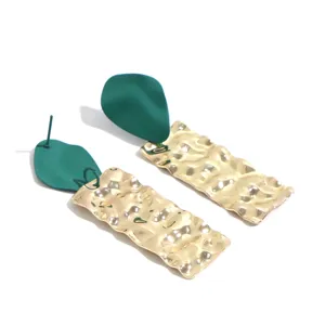 Detailed view of handmade green matte and hammered gold long dangle earrings for women.