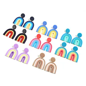 Detailed view of handmade polymer clay rainbow earrings, colorful geometric drop design.