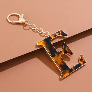 Detailansicht des Schildpatt Buchstabe E Schlüsselanhängers mit goldenem Metallverschluss.