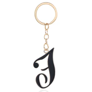 Gold metal keyring with black enamel letter pendant minimalist stylish bag charm accessory gift