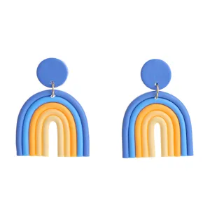 Handmade polymer clay rainbow earrings detail view featuring colorful U-shaped arches and studs.