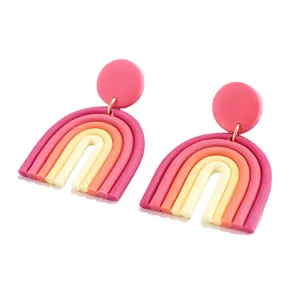 Handmade polymer clay rainbow earrings featuring creative U-shaped geometric design and vibrant tones.