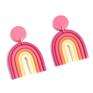 Handmade polymer clay rainbow earrings, bohemian geometric U-shaped dangle style detail shot.