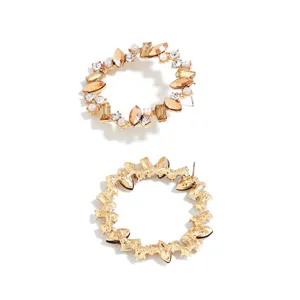 Detail view of the elegant gold-tone circular rhinestone and faux pearl stud earrings.