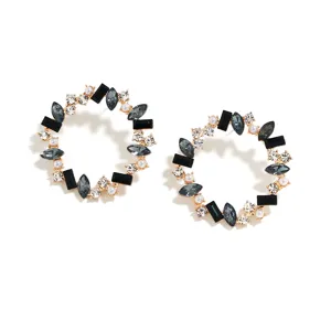 Close-up details of vintage geometric rhinestone hoop earrings with black and clear crystals.