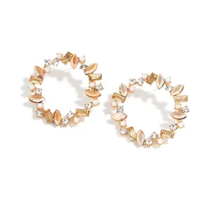 Gold circular rhinestone earrings with champagne crystals and pearls for women, detail view.