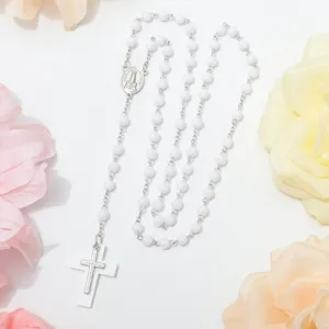 White beaded rosary necklace featuring a silver chain and cross pendant for prayer.