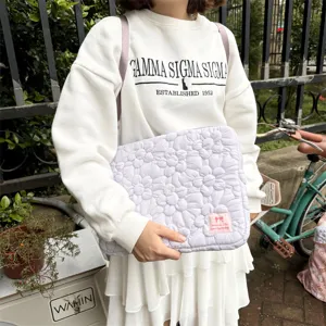 Detailed shot of Korean quilted flower laptop sleeve, soft bubble cotton texture, elegant purple color.