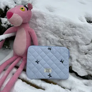 Quilted laptop sleeve with bow embroidery soft aesthetic computer storage bag detail view