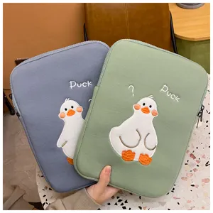 Detailed view of cute embroidered duck tablet sleeve, soft protective case for iPad.