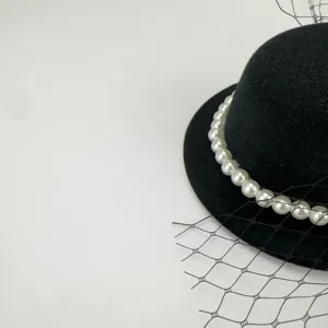 Vintage black mesh fascinator hat with elegant pearls, detailed view for women's elegant party wear.