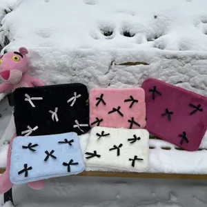 Cute plush laptop sleeve detail featuring soft material and sweet bow decorations for daily use.