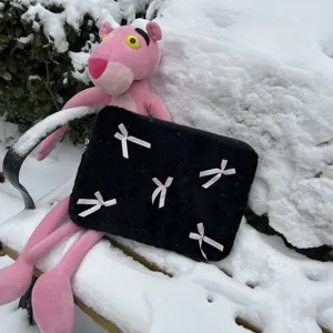 Black plush laptop sleeve with cute pink bows, soft fuzzy notebook case for women detail view.