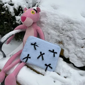 Cute blue fuzzy laptop sleeve featuring black bows, soft plush texture, excellent detail view.