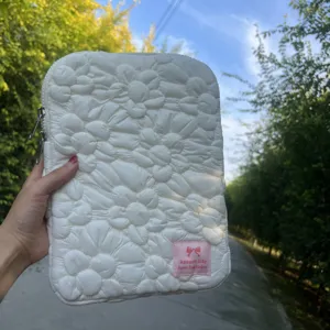 Detailed view of the Korean quilted floral laptop sleeve, soft bubble cotton texture.