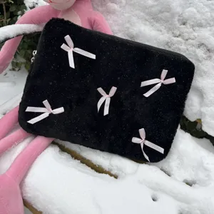 Black fuzzy laptop sleeve with cute pink bows, soft plush texture, detailed closeup view.