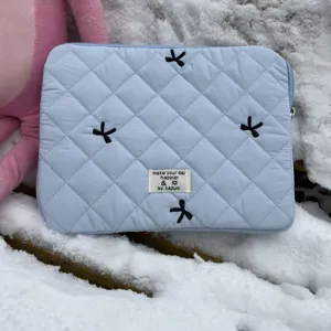 Light blue quilted laptop sleeve with black bow embroidery, cute tablet inner bag.
