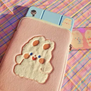 Cute pink plush iPad tablet sleeve with fluffy cartoon bear embroidery detail display.