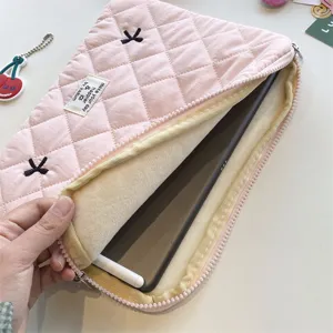 Pink quilted tablet sleeve with plush inner lining and zipper closure, cute daily tech organizer pouch.