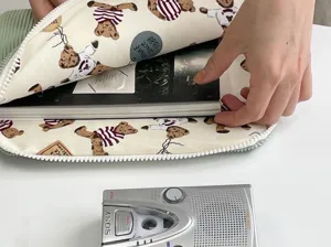 Detailed view of aesthetic corduroy tablet sleeve featuring cute teddy bear pattern design.