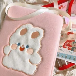 Pink plush cute tablet sleeve detail, soft texture laptop bag with adorable cartoon embroidery.