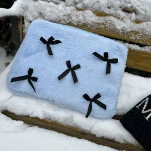 Cute light blue plush laptop sleeve with black bows, fluffy notebook storage bag.