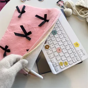 Cute pink plush laptop sleeve bag with black bows, soft protective case for daily notebook.