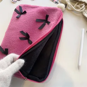 Pink plush laptop sleeve with black ribbon bows, cute fluffy tablet pouch for women and girls.