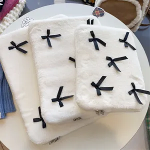 Cute fluffy plush laptop sleeve with black ribbon bows, soft white protective bag.
