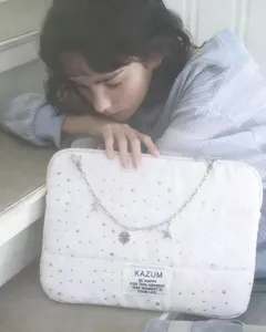 White quilted laptop bag iPad sleeve with star pattern and chic metal chain detail.