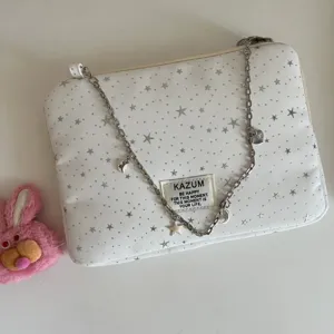 White star pattern laptop sleeve with silver chain charms and KAZUM label for daily use.