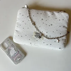 White star pattern laptop sleeve with silver chain strap, chic ballet style iPad storage bag.