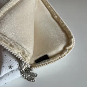 White star pattern laptop sleeve detail with soft plush inner lining and chain zipper.