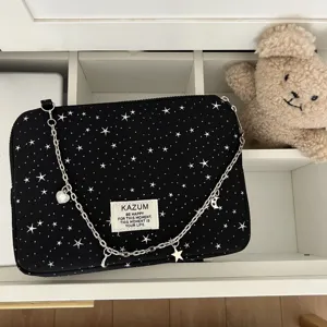 Black white star laptop bag detail, stylish chain strap with charms, iPad tablet storage sleeve.