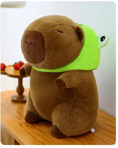 Cute brown capybara plush toy wearing green frog hat soft stuffed animal doll gift