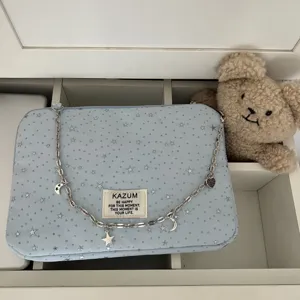 Blue star pattern laptop sleeve bag with metal chain strap and cute charms for daily use.