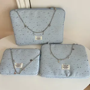 Detailed view of light blue star print laptop sleeve set with elegant metal chain charms.
