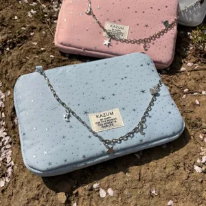 Chic star pattern laptop sleeve with charming silver chain and inspiring text label.