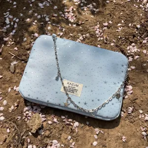 Light blue laptop sleeve with silver stars and chain strap aesthetic fashion bag.
