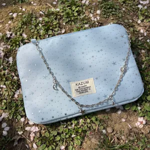 Light blue laptop sleeve with star patterns, silver chain strap, and cute charms. Stylish tablet bag.
