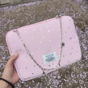 Pink laptop sleeve featuring star print, metal chain accessory, and woven label detail.